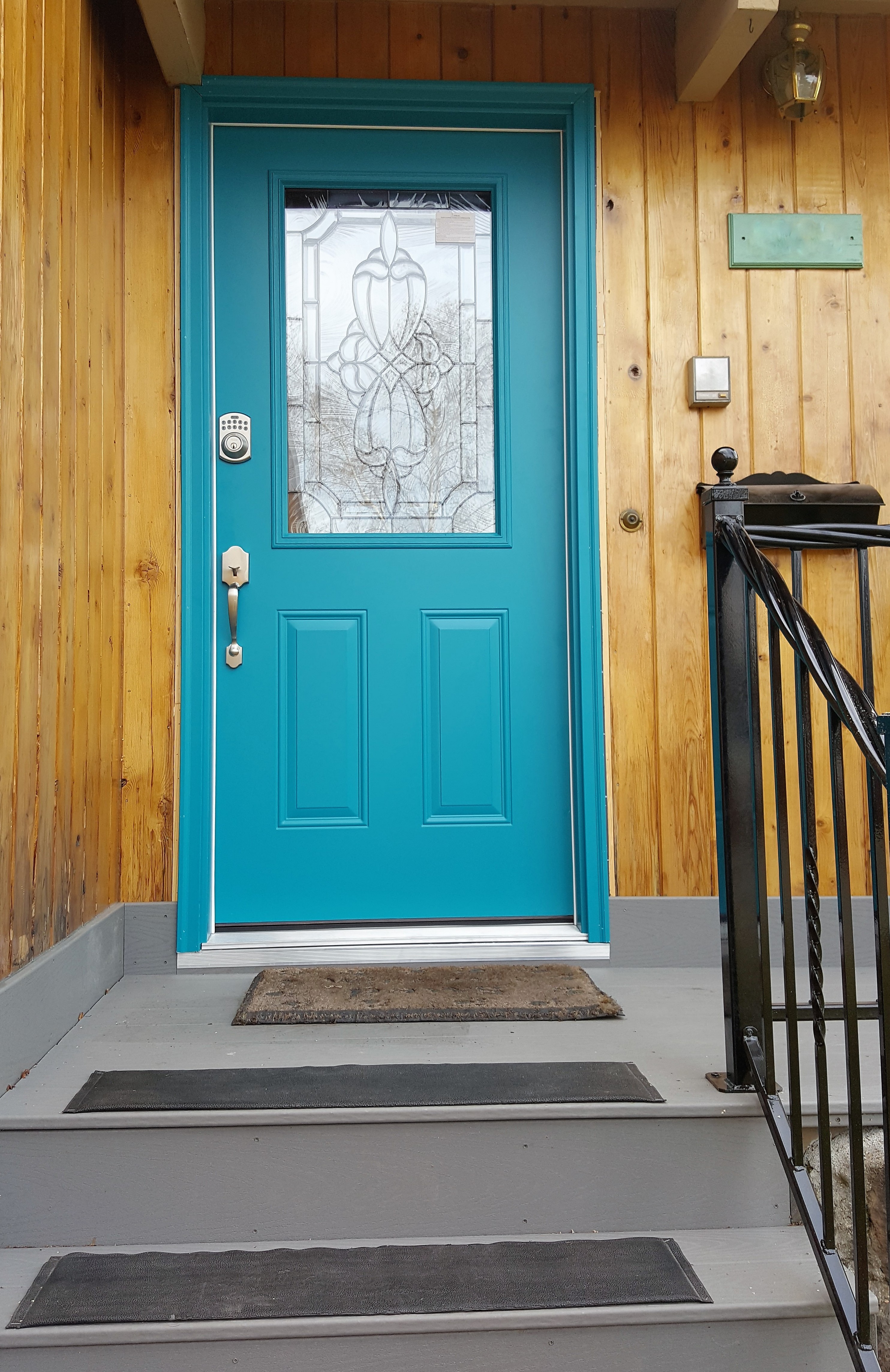 Front porch with blue door and a keypad lock