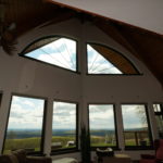 An inside view of windows looking out over a valley