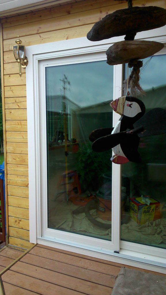 Newly installed sliding glass doors that open onto a deck