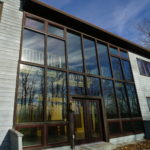 Wall of windows of different sizes in home atrium